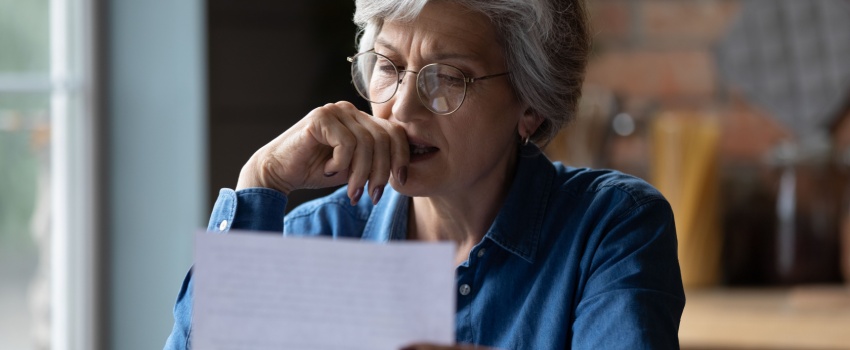 A woman reading a letter.
